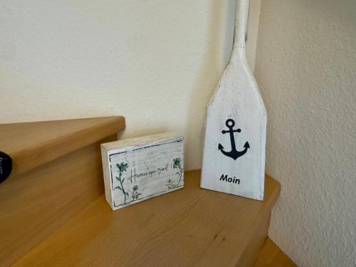 a bottle on a shelf next to a box at Ferienwohnung Petersen in Nordstrand