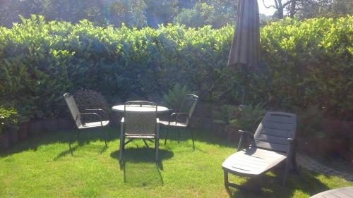 a table and chairs sitting in the grass at Haus Gemütlichkeit in Schotten