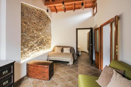 a living room with a couch and a bed in a room at Come Una Volta Apricale antica dimora ligure - Parcheggio a pochi metri in Apricale