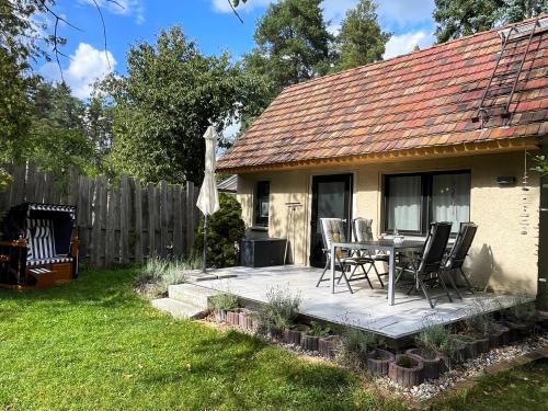 a patio with a table and chairs in front of a house at Hoffmannshof in Torno
