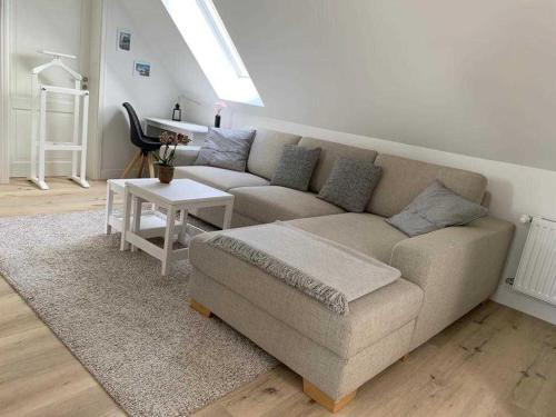 a living room with a couch and a table at Haus Lindenstraße 3 in Beckdorf