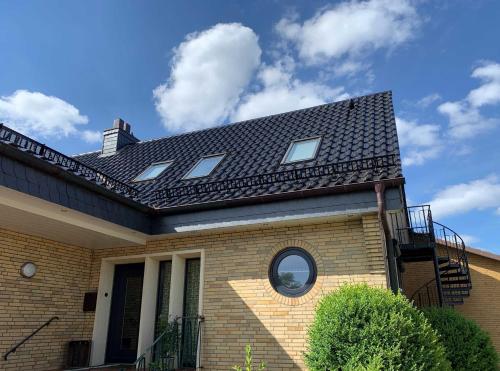 a brick house with a black roof at Haus Lindenstraße 3 in Beckdorf