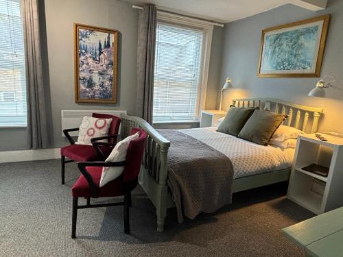 a bedroom with a bed and a chair at Marlborough Hotel in Shanklin