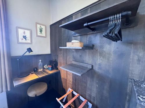 a kitchen with a table and a counter with utensils at Hotel Botaniek in Bruges