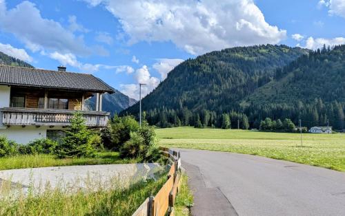 a house on the side of a road next to a field at Hoamatl in Tannheim