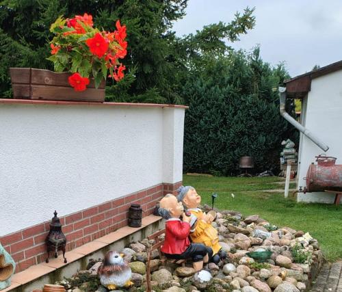 a group of figurines sitting on a rock garden at Bungalow THEA in Langhagen