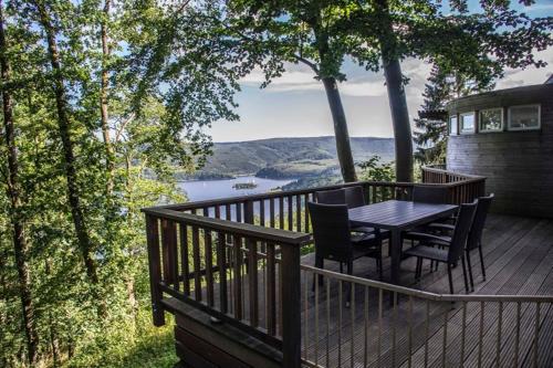 a wooden deck with a table and chairs on it at Waldhaus Anne in Simmerath