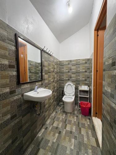 a bathroom with a toilet and a sink at A&C Aquino Guesthouse in Moalboal