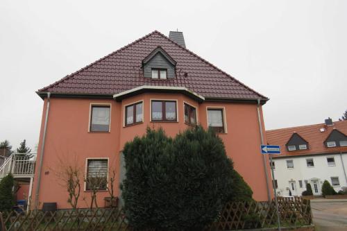 a orange house with a black roof at Ferienwohnung am Technikmuseum in Dessau