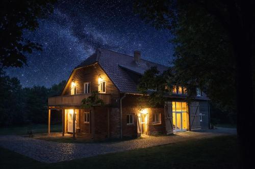 a house lit up at night with lights on at Ferienwohnungen am Obersee in Linstow