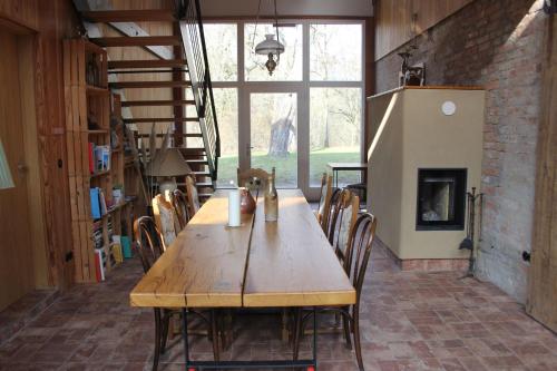 a wooden table and chairs in a room with a fireplace at Ferienwohnungen am Obersee in Linstow