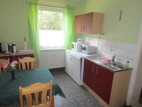 a small kitchen with a table and a microwave at Ferienhaus 2 Bernd in Barth