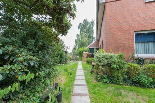 a garden path next to a brick building at Ferienwohnung Eulennest, 35230 in Schwerinsdorf