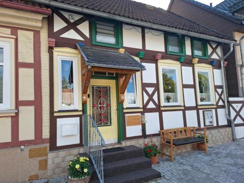 a house with a bench in front of it at Ferienhaus Max Schmeling in Benneckenstein
