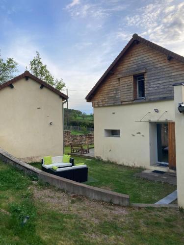 a house with a couch in front of a building at L'échappée belle - Maison - Proche Le Creusot in Marmagne