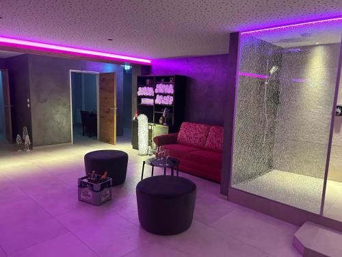 a living room with a red couch and purple lighting at Appartementhaus Leitner in Ehrwald