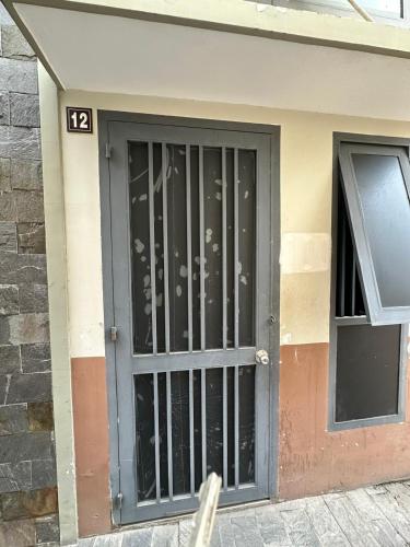 a door with a metal gate on the side of a building at Tam duc villa in Tây Ninh