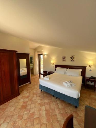 a bedroom with a large bed in a room at Villa Demetra Resort in San Leone