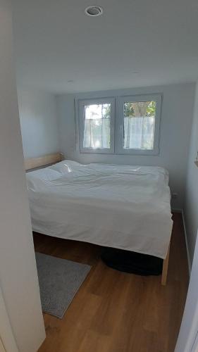a small bedroom with a bed and a window at Tiny Haus C235 Wacholderdrossel in Groß Kordshagen