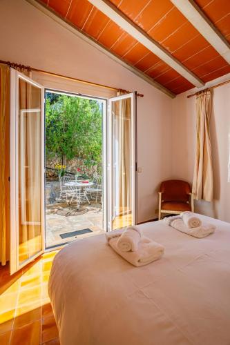 a bedroom with a bed and a large window at Can Miquel, villa in Pollensa in Pollença