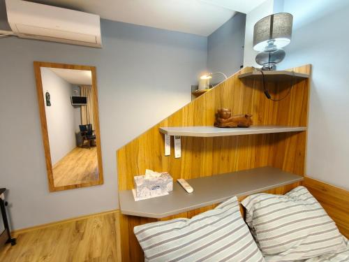 a living room with a bench and a mirror at Skalolazka 2 in Belogradchik