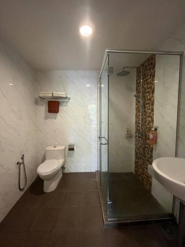 a bathroom with a shower and a toilet and a sink at D'Wharf Hotel PD Waterfront in Kampong Bangsal Kapor