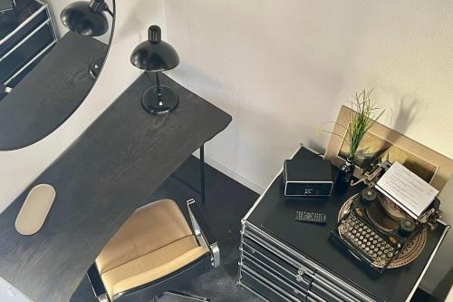 an office with a desk with a chair and a typewriter at Turmquartier Weinsberg in Weinsberg