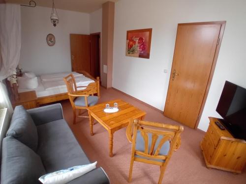 a living room with a couch and a table at Scheunen-Domizil in Bollewick