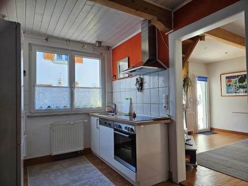 a kitchen with a sink and a stove top oven at Ferienwohnung Wartturmblick in Nierstein