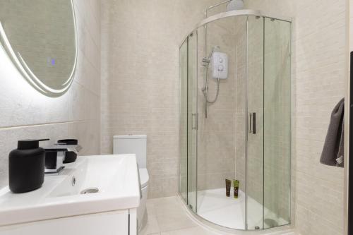 a bathroom with a shower and a sink at Modern City Centre Ground Floor - Apt 6 in Bradford