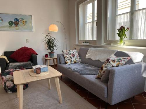 a living room with a couch and a table at Ferienwohnung am Kirchplatz 25561 in Weener