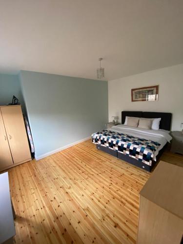 a bedroom with a bed and a wooden floor at Claddagh in Galway