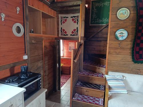 a kitchen with wooden walls and a stove in a room at Αγρόκτημα Βερνικο in Paráplati