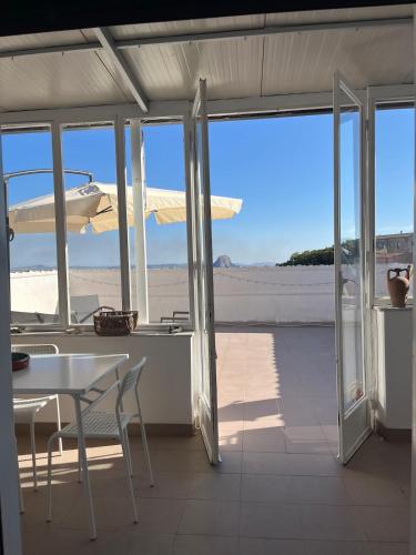 a patio with a table and a view of the beach at Casa Manzoni- Appartamento con terrazzo in centro in Mussomeli
