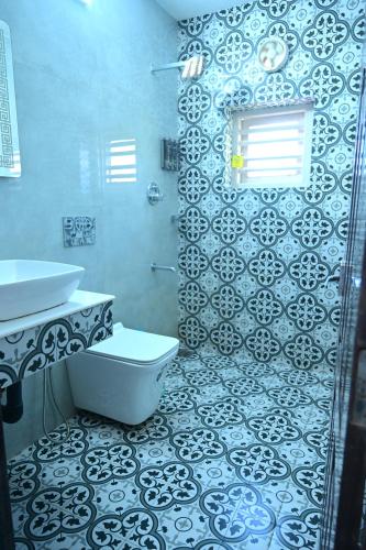a bathroom with a toilet and a sink at Kannur Beach view Homestay in Kannur