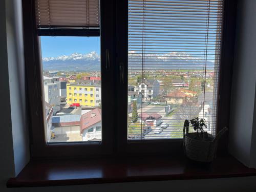 a window with a view of a city at Nido in the center in Poprad