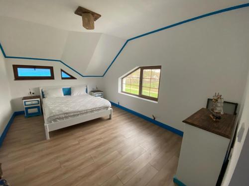 a bedroom with a bed with blue paint on the ceiling at Casa cu flori in Tulcea
