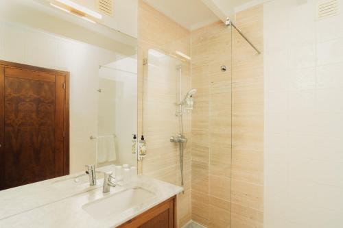 a bathroom with a sink and a shower at Topazio Vibe Beach Hotel & Apartments - Adults Friendly in Albufeira