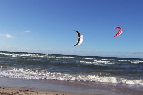two kites flying over the ocean on the beach at Warnemünde Fischer`s Hus 10139 in Rostock