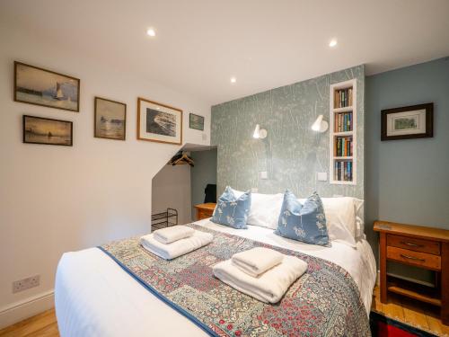 a bedroom with a bed with two towels on it at Stylish Reverse-Level Retreat for couples in Totnes