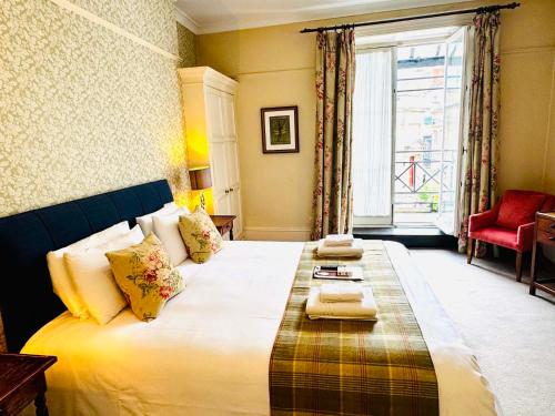 a large bed in a room with a window at George Hotel & Granary in Frome