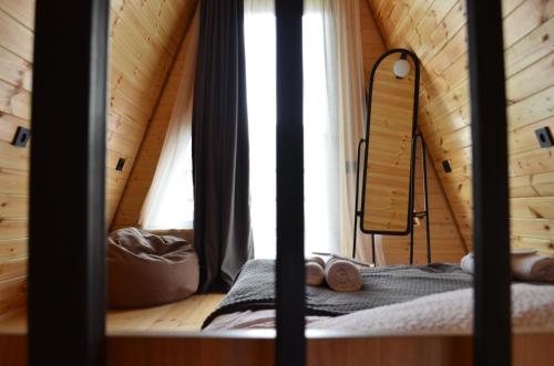 a room with a bed in a wooden cabin at MM's Cottage in Kazbegi