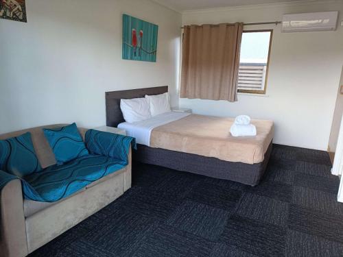a small bedroom with a bed and a couch at Motel in Nambour in Nambour