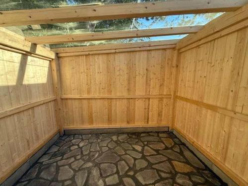an empty room with a wooden wall with a roof at Adria in Isola Albarella