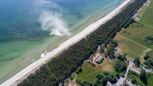 an aerial view of a house by the ocean at Haus an der Düne WE 05 in Lobbe