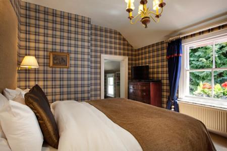 a bedroom with a bed and a window at Tir y Coed Country House in Conwy