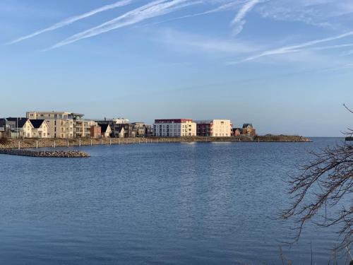 a large body of water with buildings in the background at Residenz Bollwark 3 1 in Olpenitz