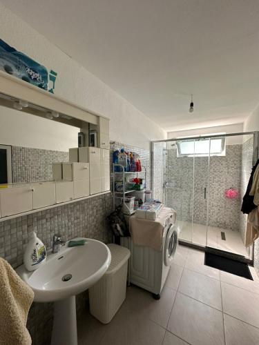 a bathroom with a sink and a washing machine at Suc Valley in Klos