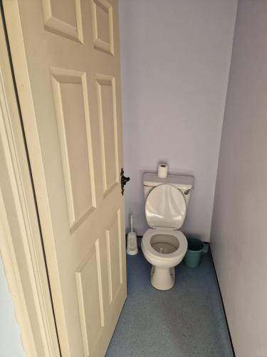 an open door to a bathroom with a toilet at Shannon Estuary Glamping Budget-Sustainable-Biodiversity Habitat--Rustic-Countryside Holiday Accommodation in Effernan