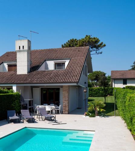 a house with a swimming pool in front of a house at Fortuna in Palazzo Vianello